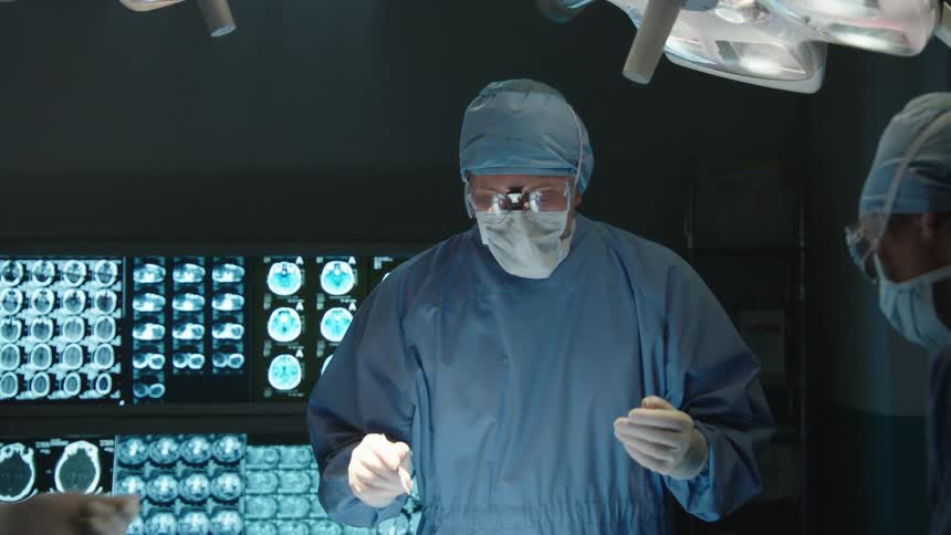 A surgeon performs an operation on a patient
