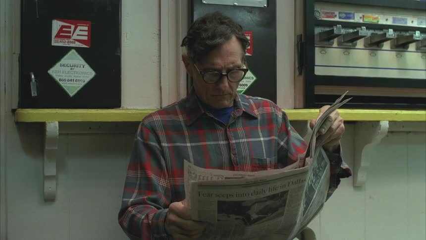 Man with prescription glasses reading a newspaper