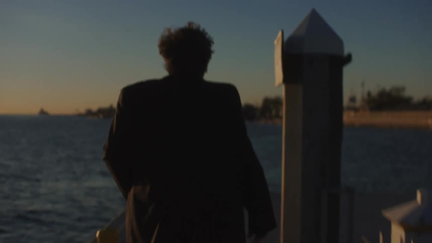 A man is running on the pier at sunrise