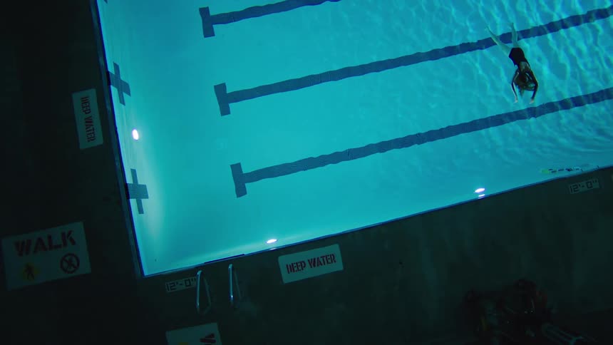 A swimmer floats in a pool