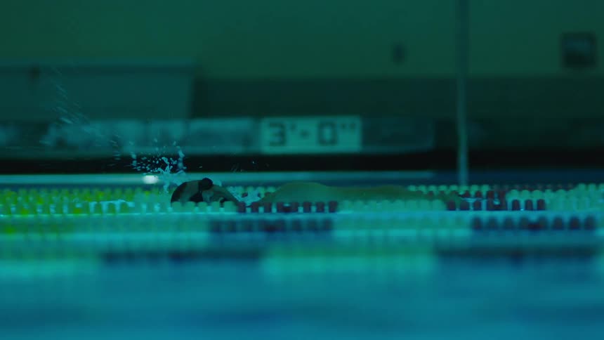 A man is swimming in the pool
