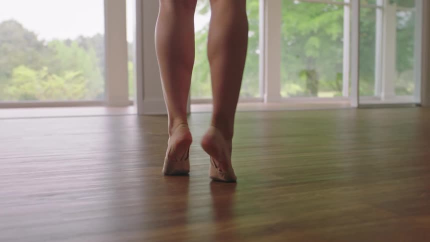 A dancer practicing in an empty room