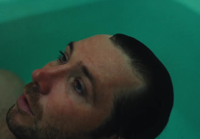 A man is talking in the bathtub