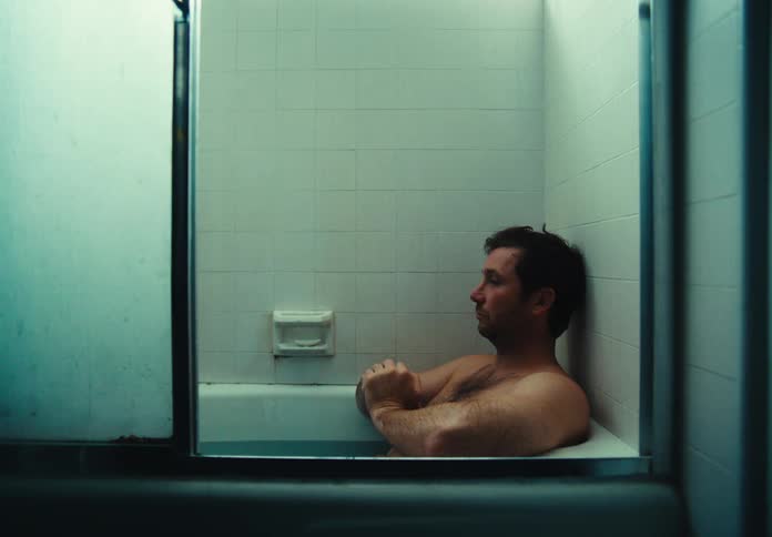 A man is sitting the bathtub