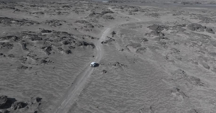 An atv driving on a desert road