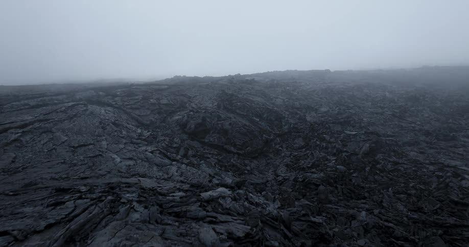 Aerial panorama of a ground with volcanic craters on a foggy day
