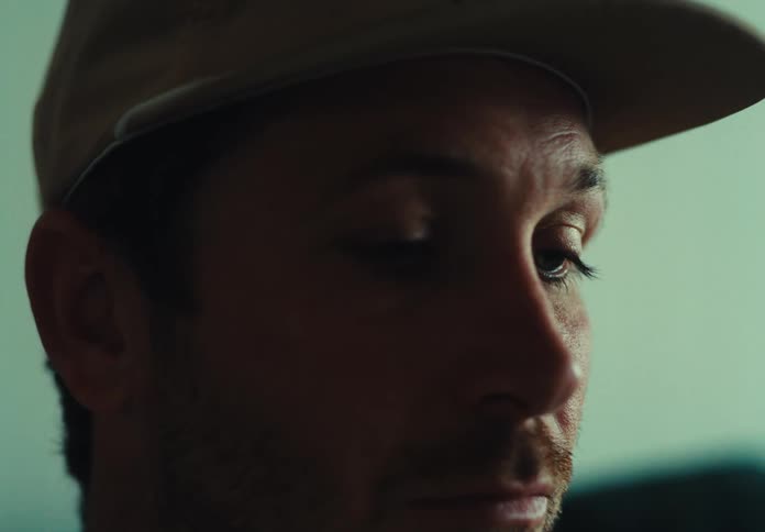Portrait of a concentrated man wearing a cap and moving only his eyes