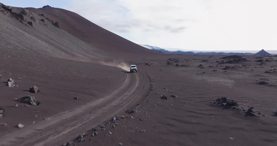 White jeep traveling on desert soil in a natural environment one morning