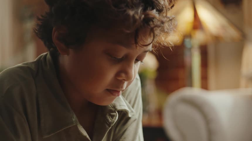 Portrait of a young little boy drawing