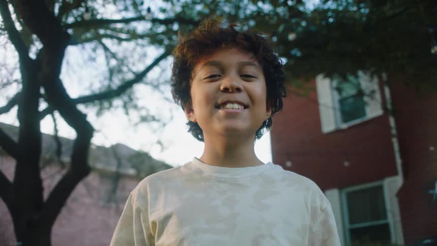 Portrait of a smiling boy in the backyard