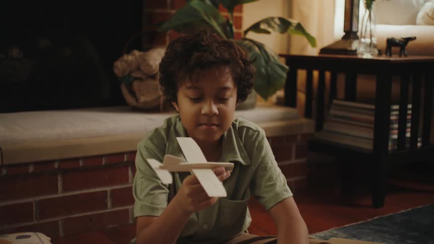 A boy is happy with a small model plane