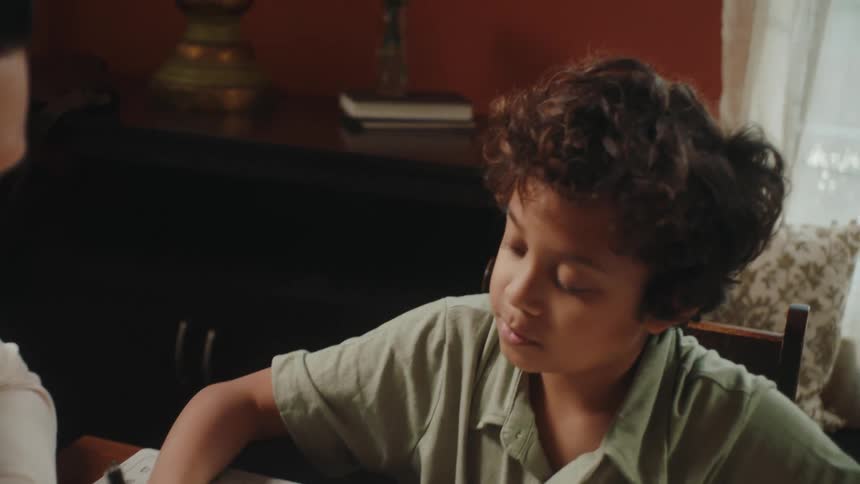 Father and son doing homework at home