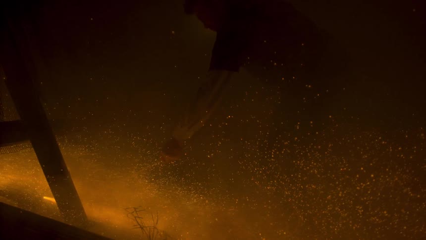 Firework sparks fly around a man