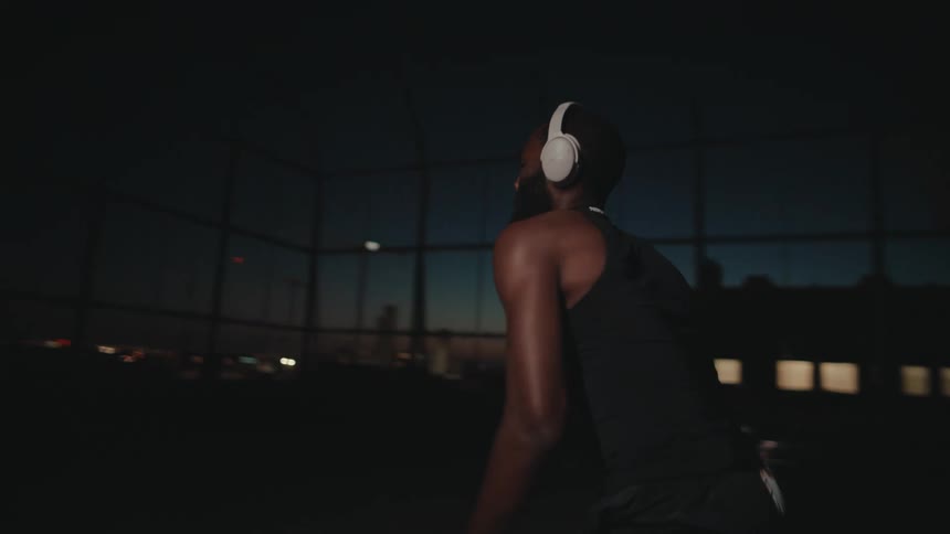 Man crossover dribbles a basketball at sunset