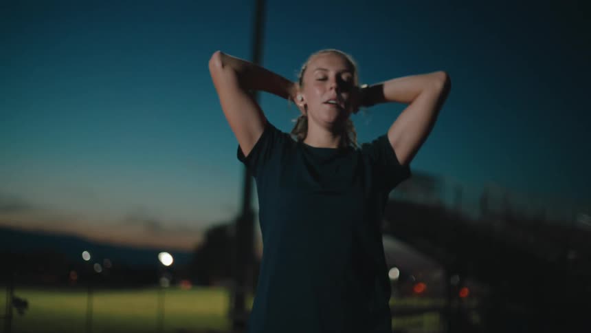Woman walks while cooling down from exercise at night