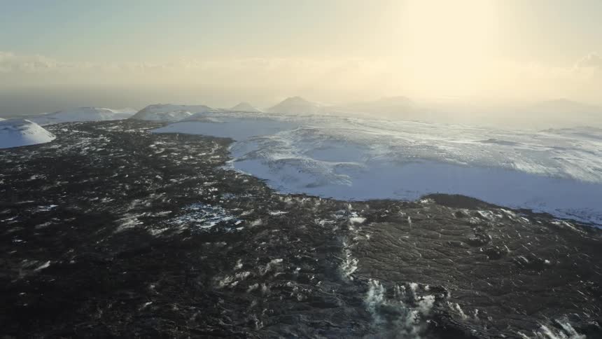 Aerial panorama of a peninsula with sea and snow and sun on the horizon