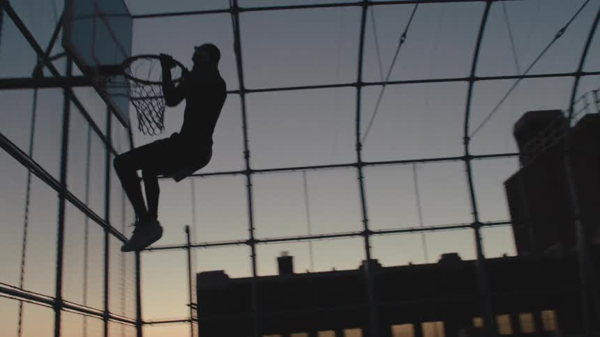 A man dunks the basketball