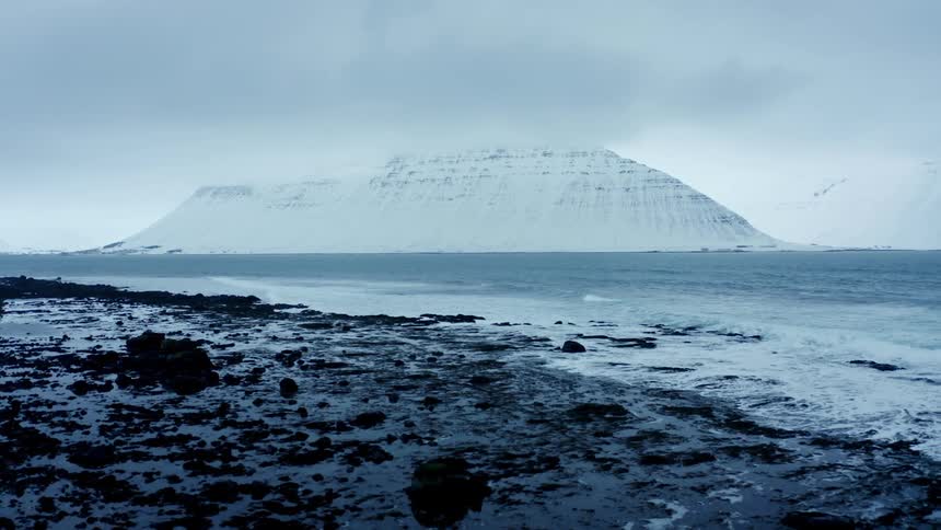 The waves crash against the shore