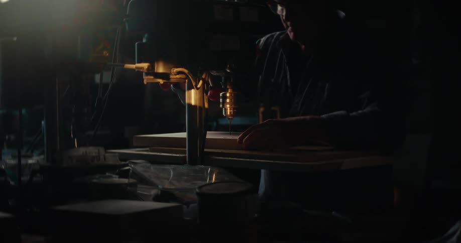 Man drilling into wood with a machine