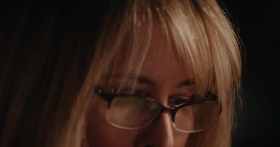 A woman looking serious while reading