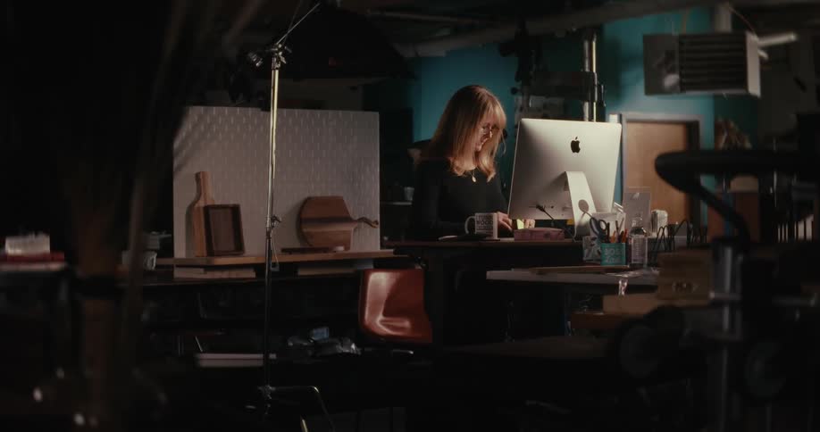 Woman sitting in an office facing a computer
