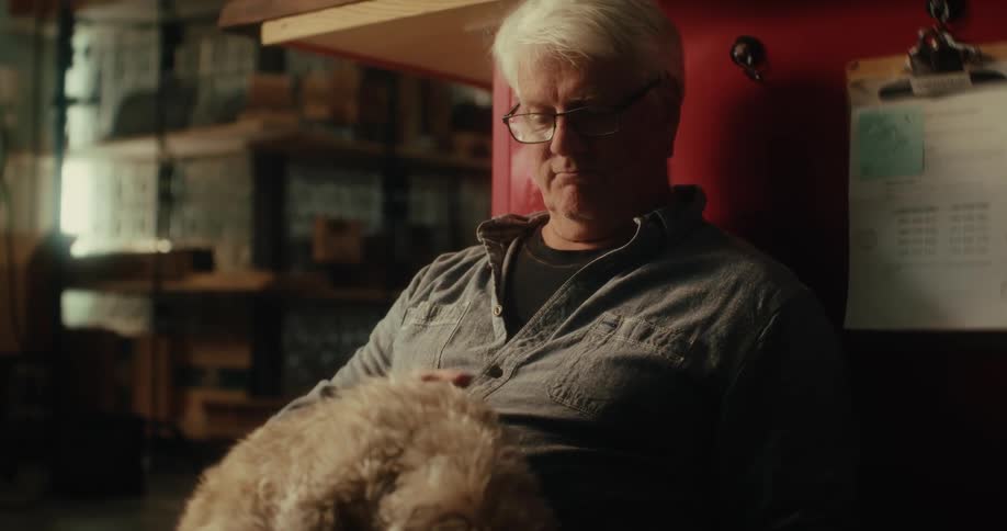 Man sitting with his dog on his lap