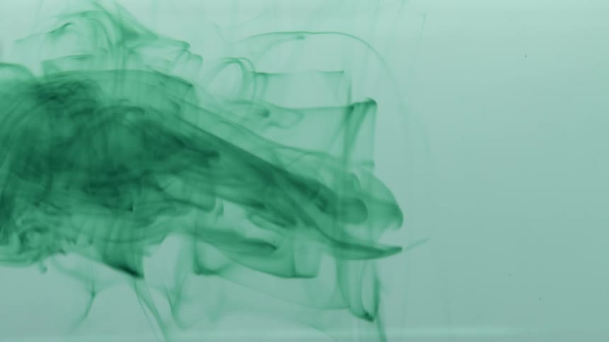 Thin rotating material releases green dye into liquid
