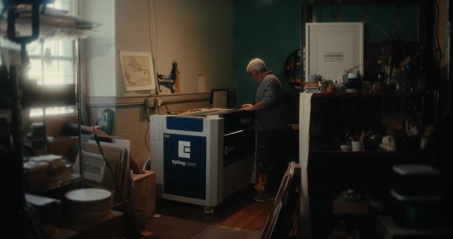 Man entering the room and closing a copier