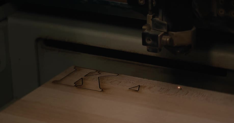 Machine stamping writing on a piece of wood