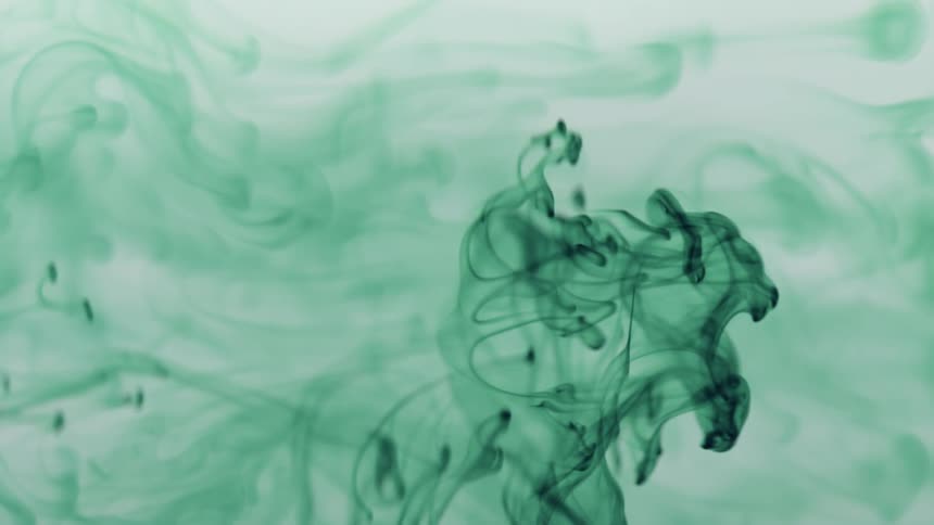 Abstract greenish liquid paint dissipating