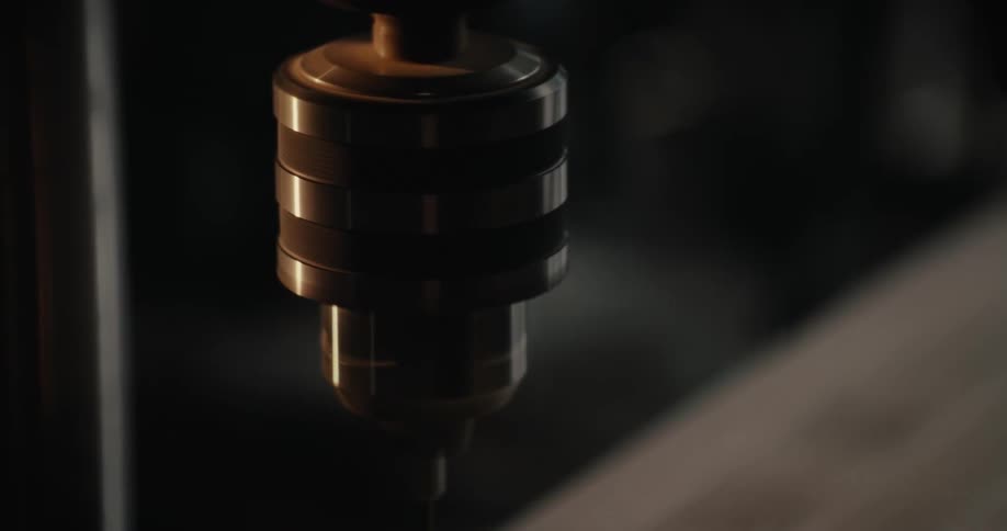 A vertical drill stopped and restarted by a hand
