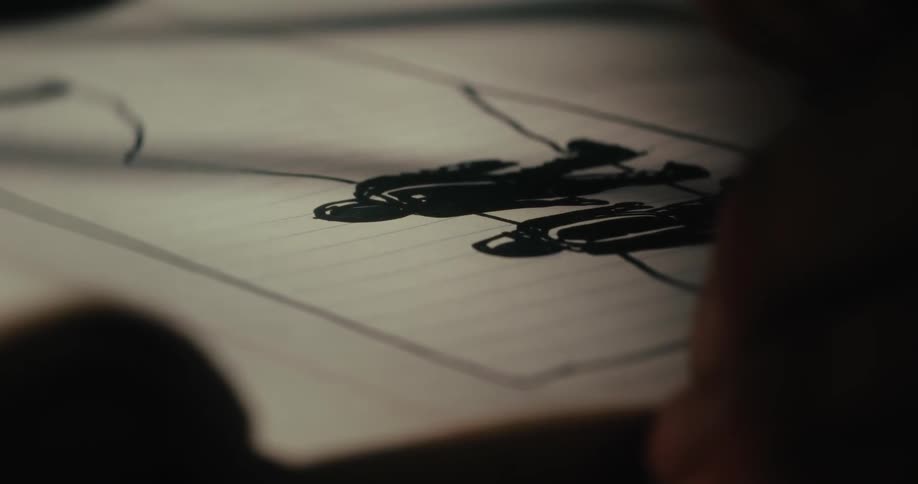 Hand holding a pen and drawing