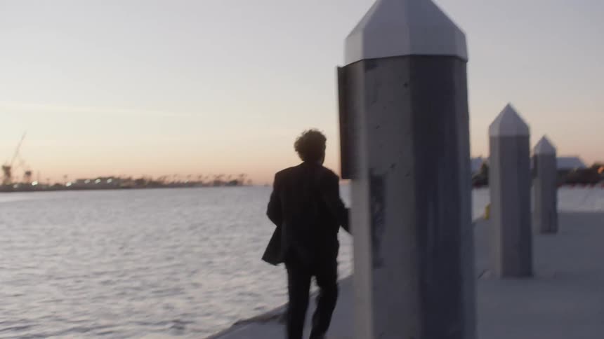 A man runs down a pier