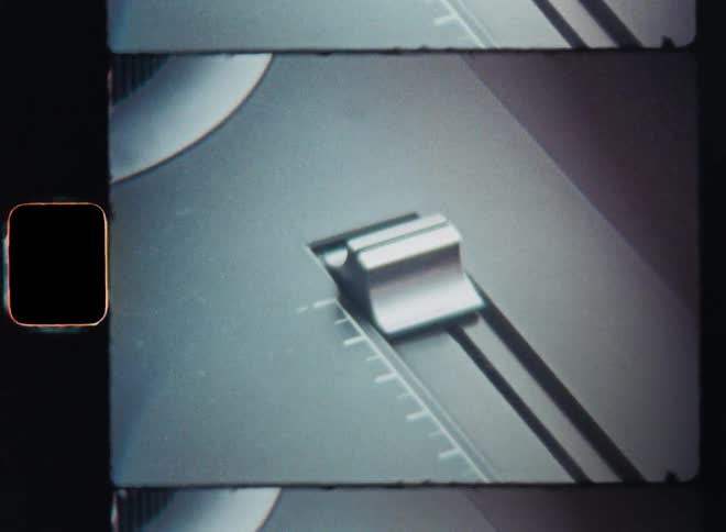 A person slides the volume or speed control of a vintage turntable up and down to change or adjust the setting as he moves the slide controller with his index finger to the desired setting to increase or decrease the parameter