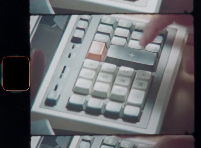 Close-up of the hands of a mathematics student doing a complicated calculation on a vintage calculator machine while hitting pressing or pushing the keys with his finger combining all numbers digits figures data and rates into a formula