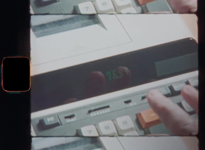 Hand of a middle-aged man manually typing digits or numbers into a retro calculator and printing a receipt as part of the accounting or bookkeeping of his small business that is overcoming a financial crisis or money problems