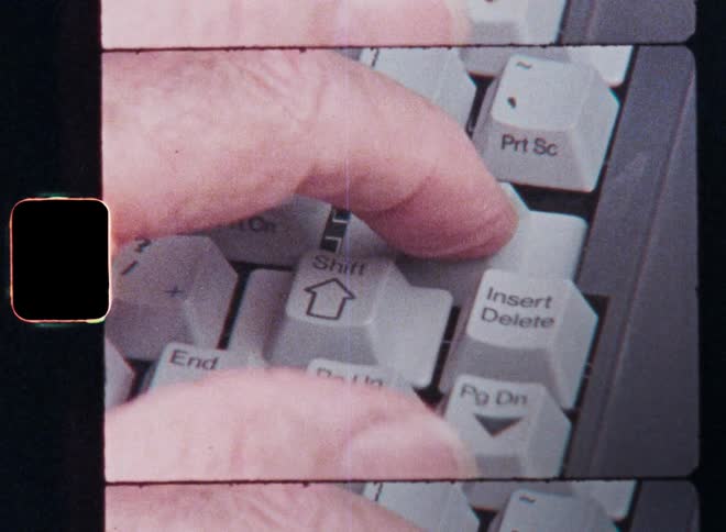 Unrecognizable person presses the return key on a laptop computer keyboard by using the index or pointer finger of his left hand filmed to enter information he filled in into the user interface or UI on Super-8 film with vintage look and film burn