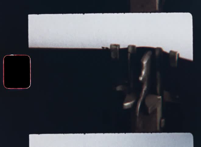 Analogue mechanical typewriter types the words happy holiday on white piece of paper wishing a great holiday season for the Christmas or Easter vacation on Super 8mm with vintage film vibes