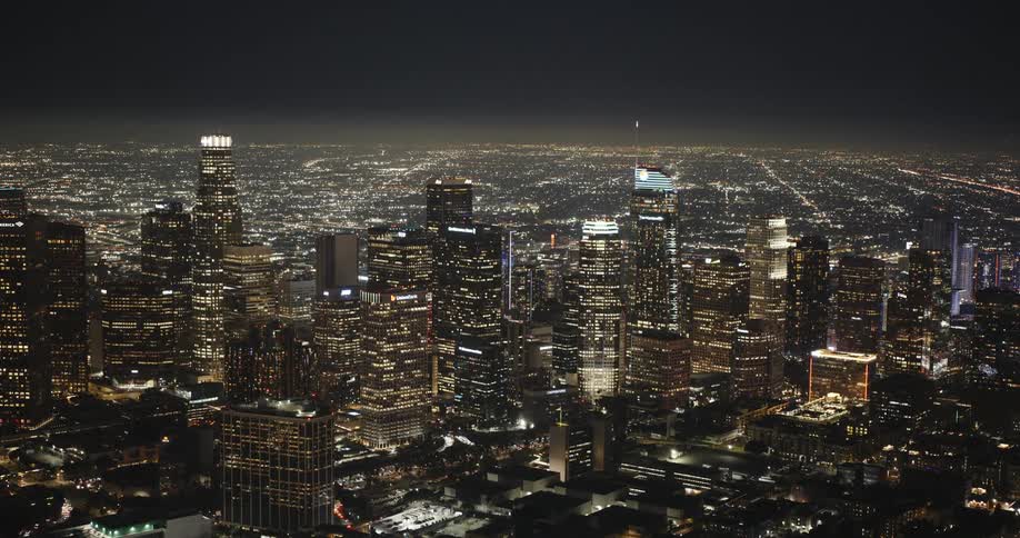Aerial panorama of a Los Angeles with skyscrapers illuminated at night