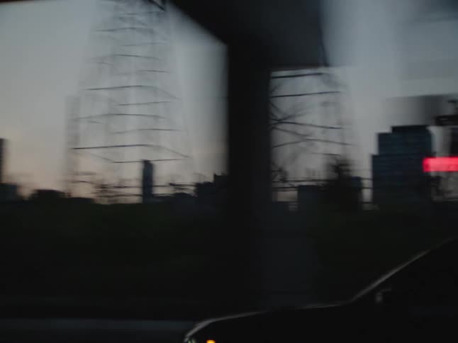 Cars drive down a road in a city