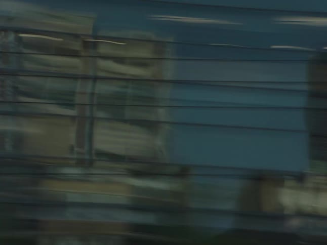 A vehicle speeds through the downtown area of the city surrounded by tall buildings