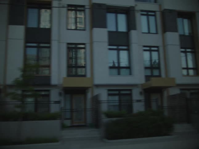 Various facades of commercial buildings seen from a moving vehicle