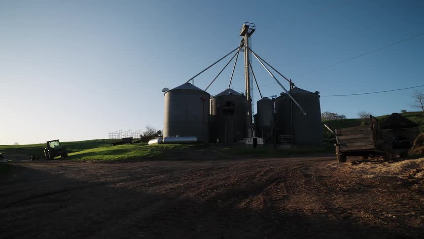 Large warehouses on a farm on a cloudless blue sky day