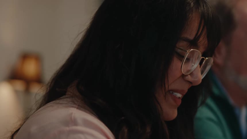 A woman talks and eats at the table
