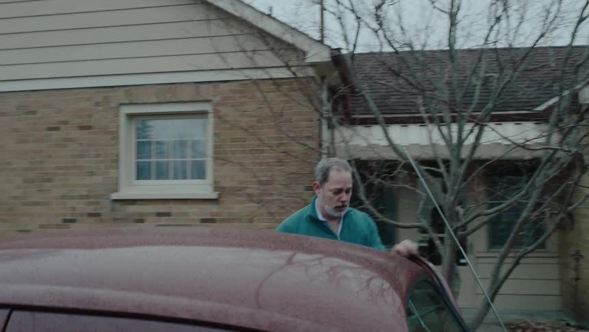 A man stands outside his car