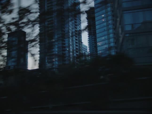 Tall buildings fill the cloudy sky