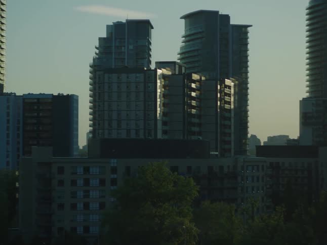 Panorama of large urban and commercial buildings in a blue dawn sky