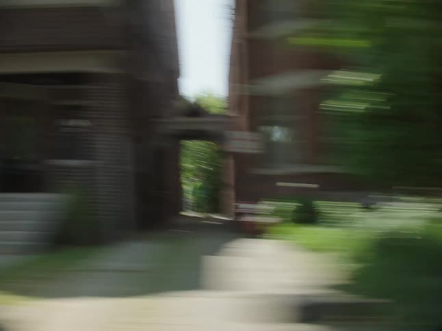 Whip pan of a suburban neighborhood from the view of a vehicle in fast motion