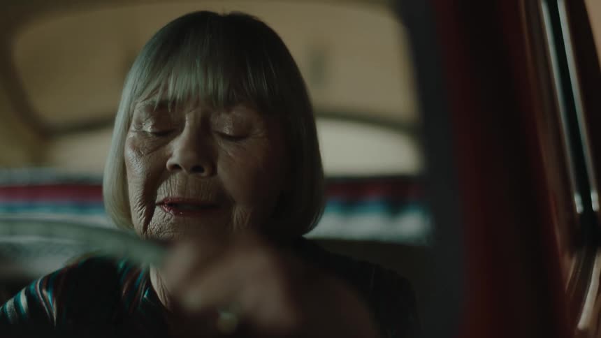 The elderly woman gets in the car