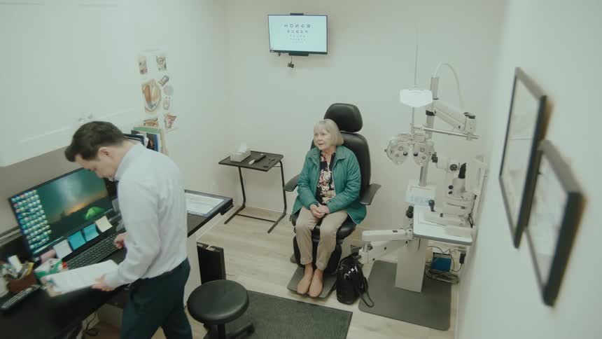 The eye doctor talks with a patient